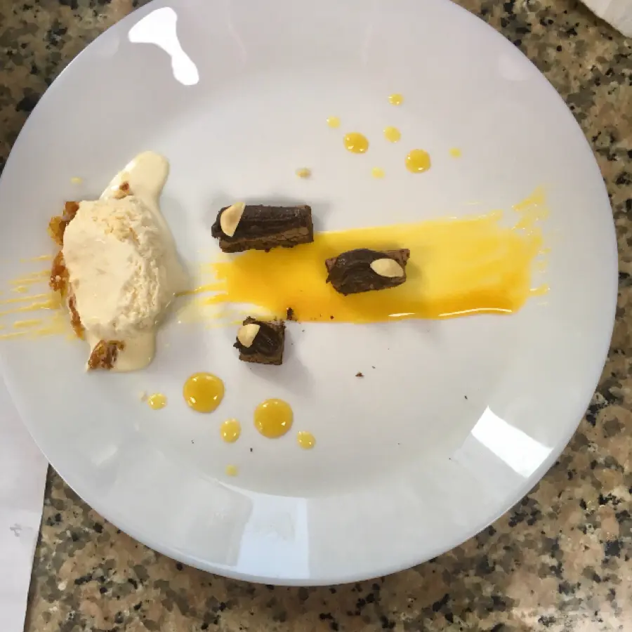 creation thumb for Chocolate biscuit with chocolate mousse, passion fruit and mango syrup, hazelnut brittle and a vanilla gelato