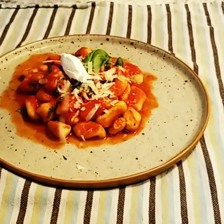 creation thumb for Hand rolled gnocchi with commodore sauce and fresh basil, topped with creamed goat cheese