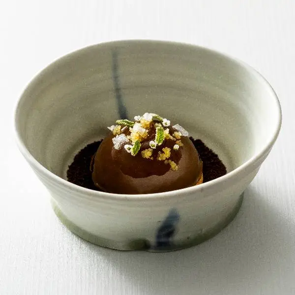 creation thumb for Chocolate dome with fresh mango, passion fruit and banana gel, encased internally with a mandarine glaze