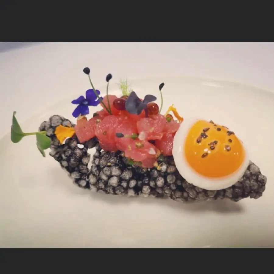 creation thumb for Tuna tostada on squid ink tapioca , pan fry quail egg , keta salmon caviar finishing with some of fresh micro greens edible flowers