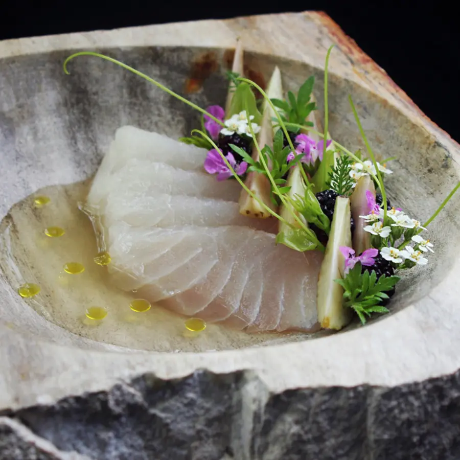 creation thumb for Gulf red snapper crudo in a chilled consommé of green tomatoes, seasoned with house made prickly pear and juniper vinegar. Preserved green strawberries, mulberries, wild herbs from our native plants garden and an oil infused with burnt tomato shoots.